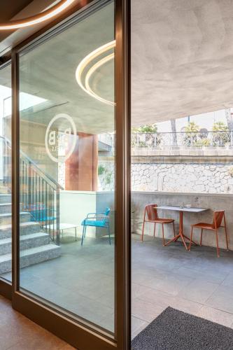 a glass door in a room with a table and chairs at B&B Hotel Genova City Center in Genova