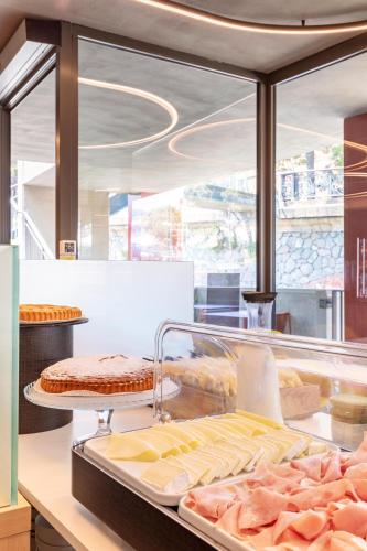 a display case with various types of food on a counter at B&B Hotel Genova City Center in Genova