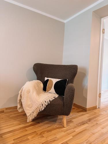 a chair with a blanket on it in a room at Striķu15 - Dzīvoklis ar terasi in Saldus