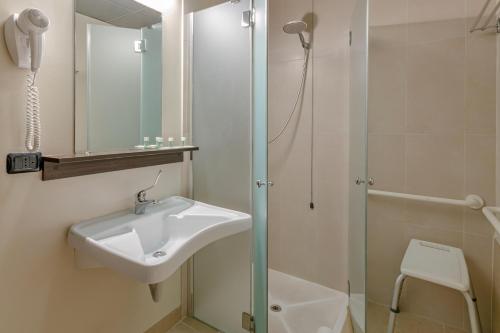 a bathroom with a sink and a shower at B&B Hotel Firenze City Center in Florence