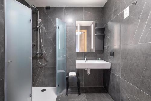 a bathroom with a sink and a shower at B&B Hotel Genova City Center in Genova