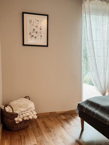 a room with a bed and a chair next to a window at Striķu15 - Dzīvoklis ar terasi in Saldus