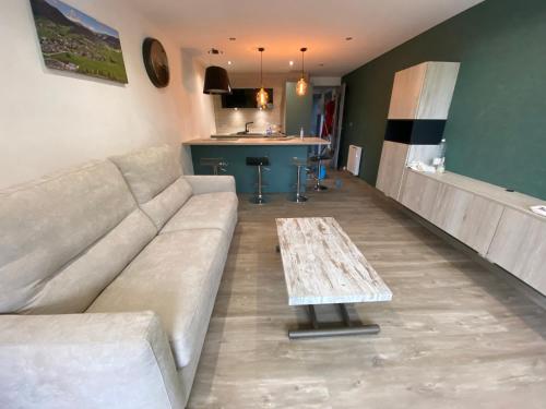 un salon avec un canapé et une table dans l'établissement Le Claret, à Autrans