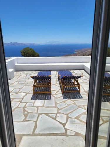 a view of a patio with two picnic tables at Balcony to the Aegean in Stení