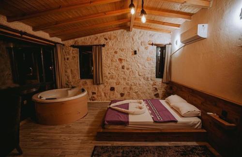 a bathroom with a tub and a bed in it at villa sunrise in Demre