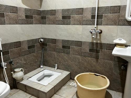 a bathroom with a toilet and a sink at House for Short Term Renting in Sargodha