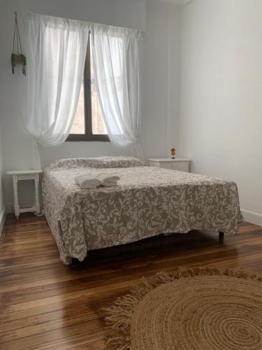 a bedroom with a bed and a window at piso céntrico en Bilbao in Bilbao
