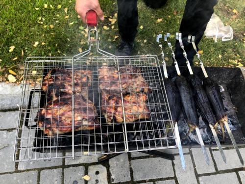 a person is cooking meat on a grill with tongs at Deluxe Royal Beach in Chok-Tal