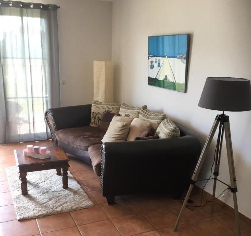a living room with a couch and a table at Schöne Wohnung mit Boddenblick in Sagard