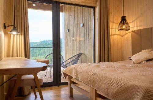 a bedroom with a bed and a balcony at Шале Green Land in Bukovel