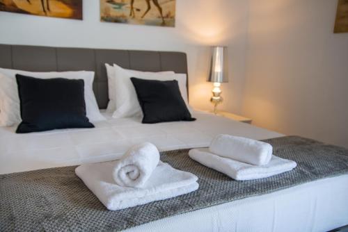 a bedroom with a bed with towels on it at Kalokairia Residence in Gaios