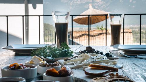a wooden table with food and drinks on a table at Kikonia Art & Suites in Akyaka