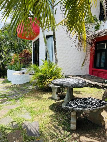 a table and bench in front of a house at Exclusive Altos del Maria 2 Bedroom Apartment-Private Pool & Mountain Views in Sorá