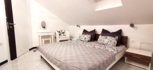 a bedroom with a large bed with pillows at Appartman Tia in Polje