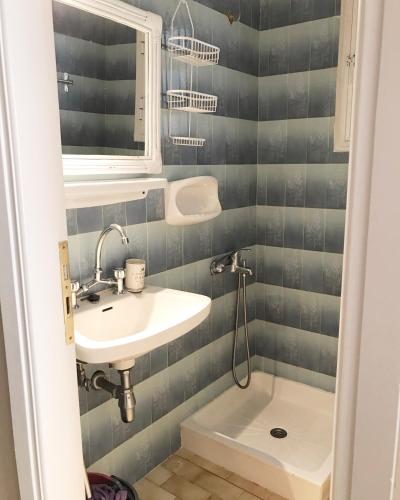 a small bathroom with a sink and a toilet at Rigas Apartment in Artemida