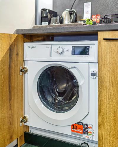 a washing machine in a kitchen under a counter at Mursala Pamporovo in Pamporovo