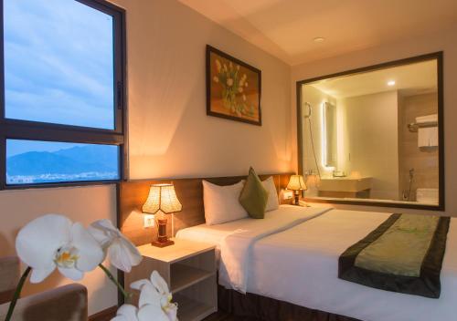 Postel nebo postele na pokoji v ubytování BN Boutique Nha Trang Beach