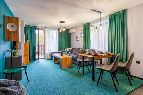 a living room with a table and a couch at Mursala Pamporovo in Pamporovo