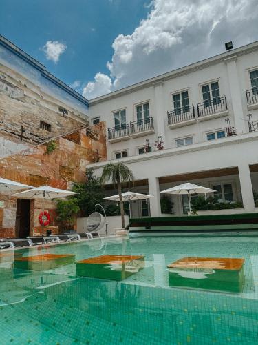a large swimming pool in front of a building at Alentejo Marmòris Hotel & Spa in Vila Viçosa
