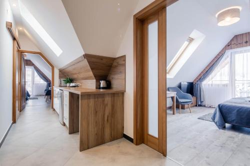 a room with a bed and a desk in a room at Willa Marti GOLD in Zakopane