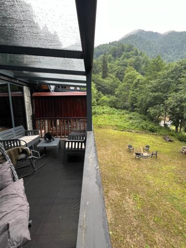 a view of a porch with benches and a field at AYDER VANAK STONE SUİTES in Ayder Yaylasi