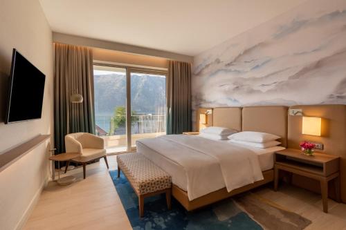 a hotel room with a large bed and a window at Hyatt Regency Kotor Bay Resort in Kotor