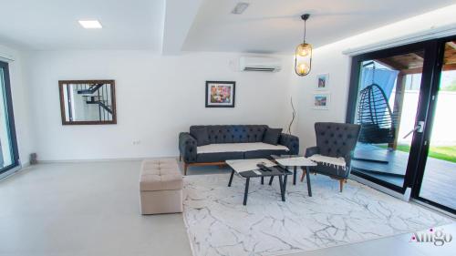a living room with a couch and a table and chairs at Bunska Venera in Blagaj