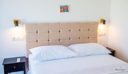 a bedroom with a large white bed with two pillows at Bunska Venera in Blagaj