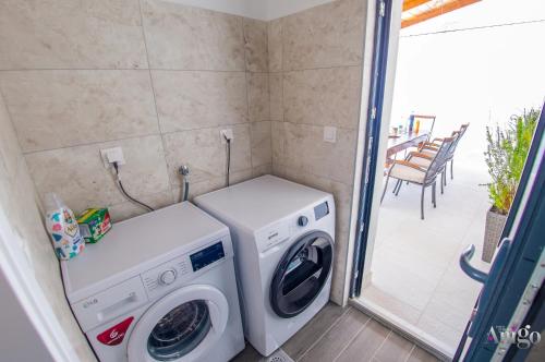 a washer and dryer in a room with a patio at Bunska Venera in Blagaj