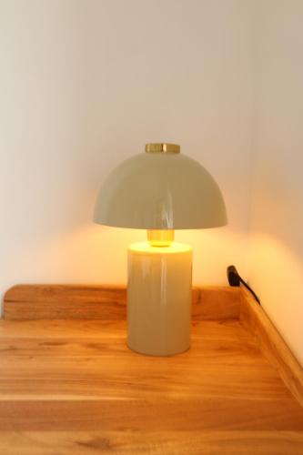 a lamp sitting on top of a wooden table at Le Clos Normand in Saint-Aubin-sur-Mer