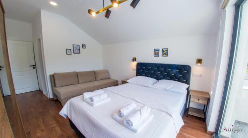 a bedroom with a large bed and a couch at Bunska Venera in Blagaj