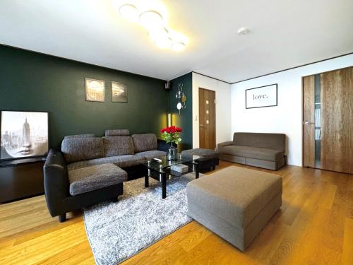 a living room with a couch and a table at guesthouse大阪城 in Osaka