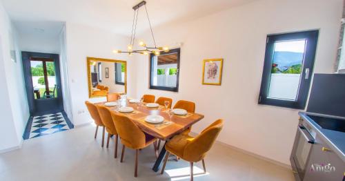 a dining room with a wooden table and chairs at Bunska Venera in Blagaj