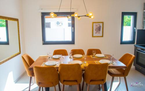 a dining room with a wooden table and chairs at Bunska Venera in Blagaj