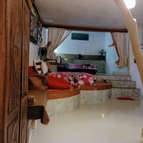 a bedroom with a large bed with red pillows at Rara Villas Lombok in Senggigi 