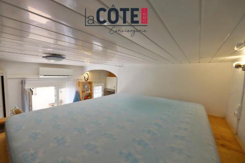 - un lit dans une chambre avec un panneau mural dans l'établissement Les Pins, à Sausset-les-Pins