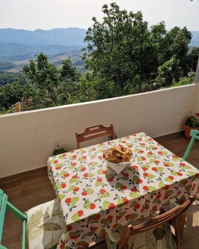 a table and chairs with a tablecloth on a table at Guest House Vajzë S,Kasaj in Vlorë