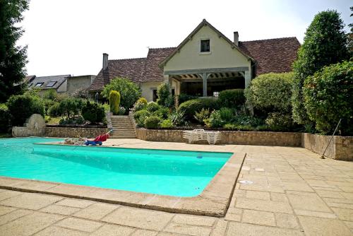 une maison avec une piscine devant une maison dans l'établissement Le domaine du chêne vert, à Monthou-sur-Bièvre
