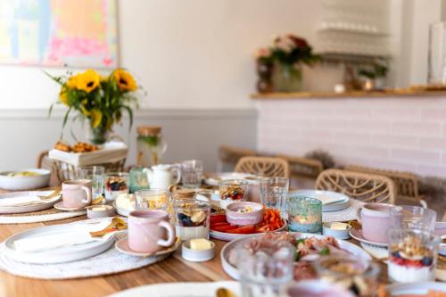 a table with plates and cups of food on it at Inselpension Henriette in Norderney