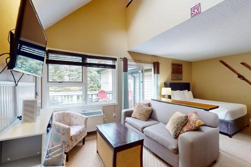 a hotel room with a bed and a living room at Condo 912 at North Creek Resort in Blue Mountains