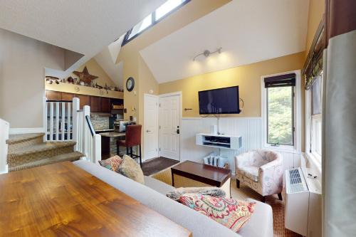 a living room with a couch and a tv at Condo 912 at North Creek Resort in Blue Mountains
