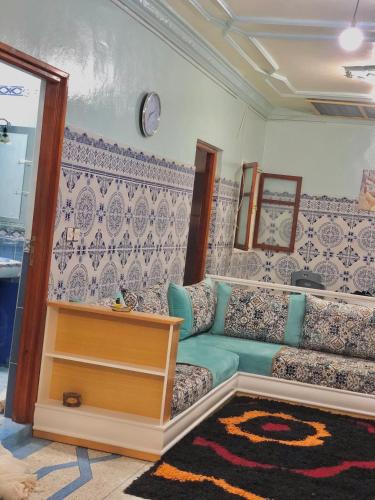 a living room with a couch and a table at Peaceful and cozy appartement, very good location in Sidi Slimane