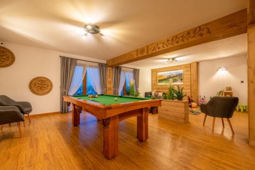 a living room with a pool table in it at Willa Marti GOLD in Zakopane