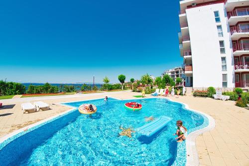 a swimming pool with a water slide in a resort at Sea view apartment in paradise in Elenite