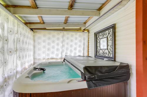 a bath tub in a room with avertisementatronatronstrationstration at North Fairfield Family Home with Hot Tub and Porch! in Willard