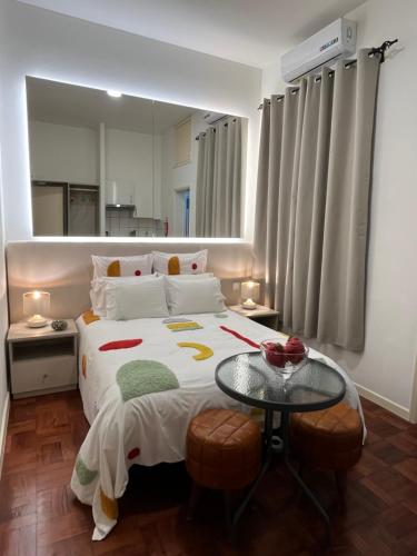 a bedroom with a large bed and a table at Bella Vista in Funchal