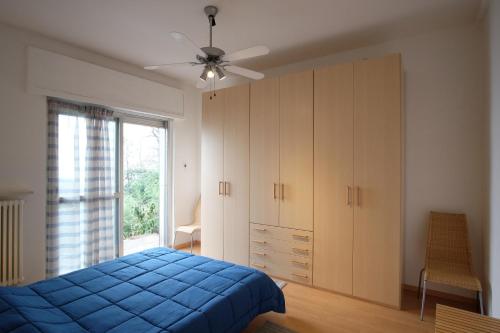 a bedroom with a blue bed and a window at Lago Blu in Stresa
