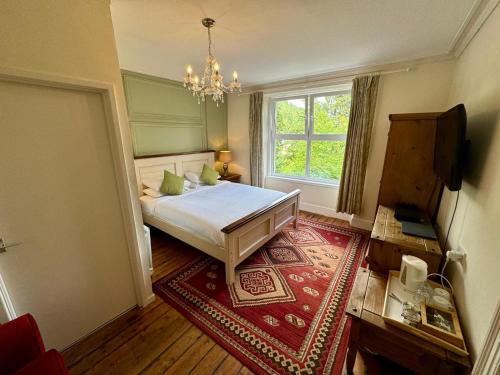 a bedroom with a bed and a window at Fairhaven in Betws-y-coed