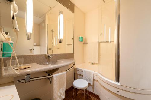 a bathroom with a sink and a shower at Novotel Roma Est in Rome