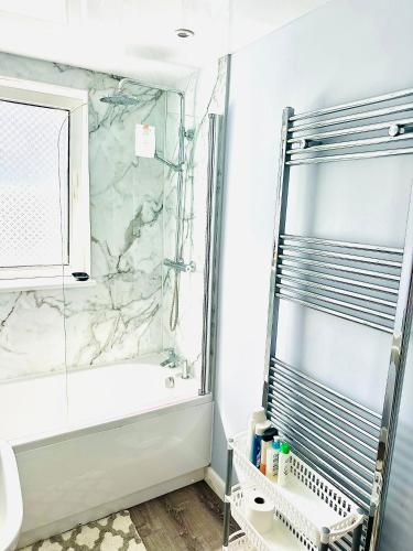 a bathroom with a shower and a tub and a sink at Grace Court in Aberdeen